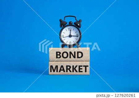 Bond Market symbol. Concept words Bond Market on wooden blocks. Beautiful blue background with alarm clock. Business and Bond Market concept. Copy space. 127620261