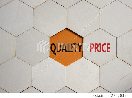 Price or Quality symbol. Concept word Price or Quality on wooden comb puzzle. Beautiful orange background. Business and Price or Quality concept. Copy space Price or Quality symbol. Concept word Price or Quality on wooden comb puzzle. Beautiful orange background. Business and Price or Quality concept. Copy space 127620332