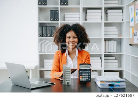 African woman working with House model real estate agent and customer discussing for contract to buy house, insurance or loan real estate consult concerning mortgage loan offer African woman working with House model real estate agent and customer discussing for contract to buy house, insurance or loan real estate consult concerning mortgage loan offer 127621687