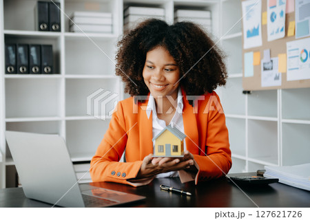 Successful African Businesswoman Analyzing Finance on Tablet and Laptop at modern Office Desk tax, Successful African Businesswoman Analyzing Finance on Tablet and Laptop at modern Office Desk tax, 127621726