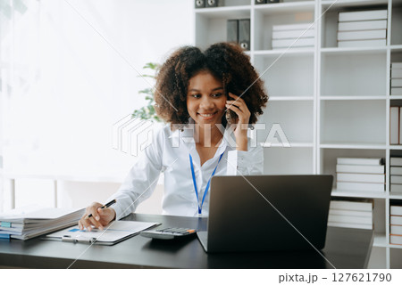 Successful African Businesswoman Analyzing Finance on Tablet and Laptop at modern Office Desk tax, Successful African Businesswoman Analyzing Finance on Tablet and Laptop at modern Office Desk tax, 127621790