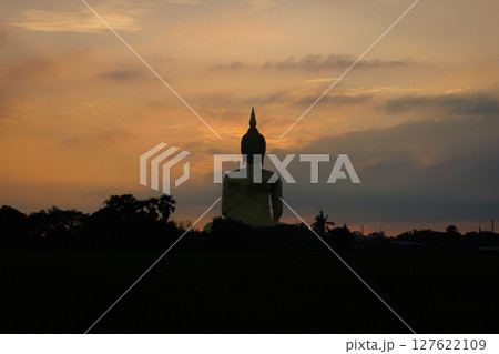 The largest golden Buddha statue with green rice field foreground at Wat Muang Temple in Ang Thong Province, Thailand. 127622109