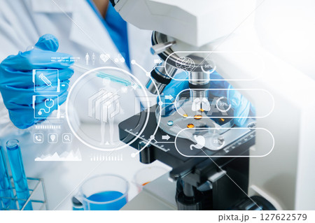 DNA molecule testing concepts. The doctor in a mask examines DNA molecules on the chemical laboratory with virtual icon 127622579