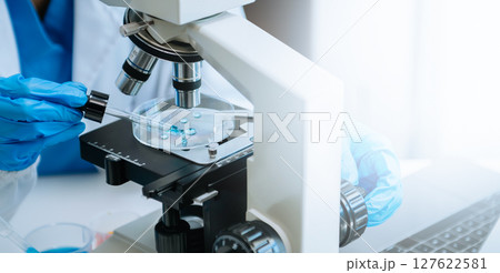 Modern medical research laboratory. female scientist working with micro pipettes analyzing biochemical samples, advanced science chemical laboratory Modern medical research laboratory. female scientist working with micro pipettes analyzing biochemical samples, advanced science chemical laboratory 127622581
