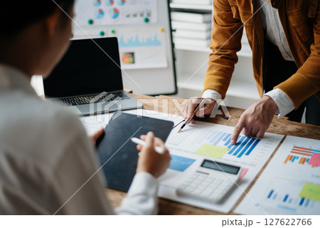 Business people meeting at office writing notes about sticky notes Laptop,tablet  Planning and Brainstorming Strategies of Colleagues 127622766