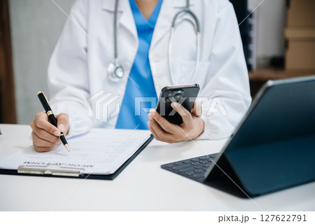 Medical technology concept. Doctor working with mobile phone and stethoscope and digital tablet laptop in office at hospital 127622791