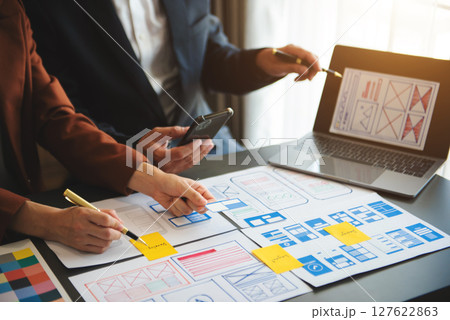 Asian businessman and woman people meeting in office. Employee brainstorm and work as team, plan and discuss project by point on paper 127622863