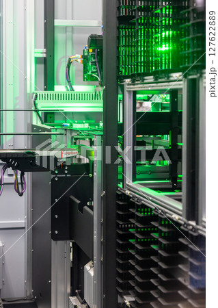 Automated industrial storage system with green light, Smart warehouse automation modern storage and retrieval system, Industry 4.0 automated robotic storage warehouse. Automated industrial storage system with green light, Smart warehouse automation modern storage and retrieval system, Industry 4.0 automated robotic storage warehouse. 127622889