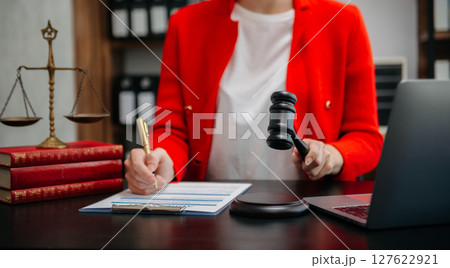 justice and law concept.Male judge in a courtroom the gavel, working with smart phone and laptop and digital tablet computer on table justice and law concept.Male judge in a courtroom the gavel, working with smart phone and laptop and digital tablet computer on table 127622921