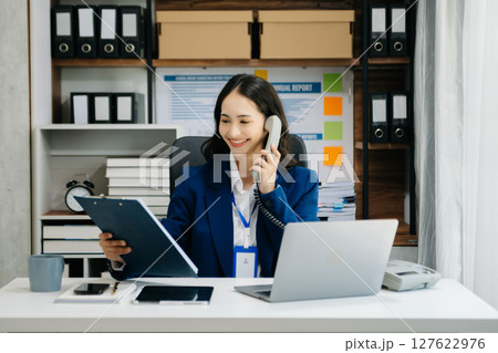 Woman freelancer is working her job on computer tablet and laptop Doing accounting analysis report real estate investment data, Financial 127622976