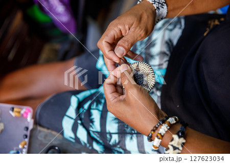 Mangyan Village in Talipanan Puerto Galera Oriental Mindoro Philippines closeup of hands making native ornament 127623034