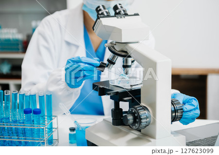 Modern medical research laboratory. female scientist working with micro pipettes analyzing biochemical samples, advanced science chemical laboratory 127623099