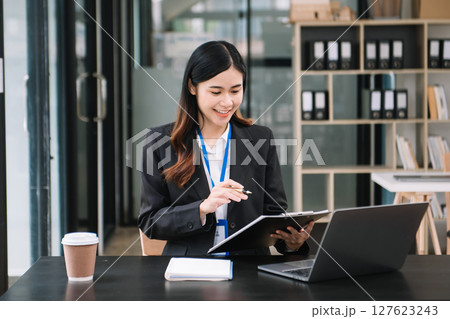 Confident business expert attractive smiling young woman holding digital tablet on desk in office. Confident business expert attractive smiling young woman holding digital tablet on desk in office. 127623243