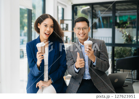 Businesswomen work and discuss their business plans. A Human employee explains and shows her colleague the results paper Businesswomen work and discuss their business plans. A Human employee explains and shows her colleague the results paper 127623951