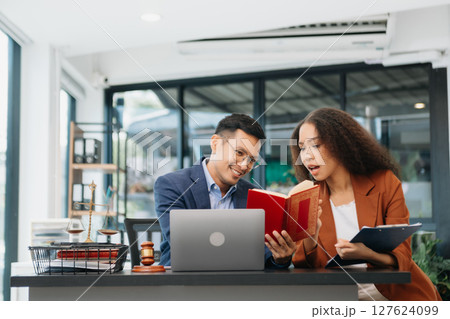 business people and lawyers discussing contract papers sitting at the table. Concepts of law, advice, legal services. 127624099