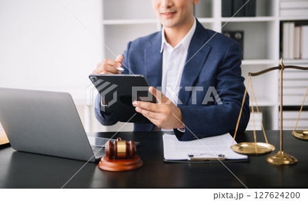 justice advice and law judge legislation concept. tribunal Attorney lawyer working with documents and white gavel on tabel 127624200