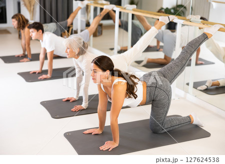 Group of different ages healthy lifestyle practicing pilates at studio Group of different ages healthy lifestyle practicing pilates at studio 127624538