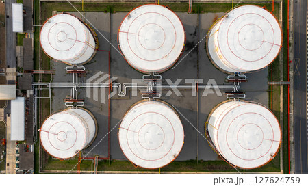 Aerial top view petrochemical plant oil refinery storage tank pipe line at night, Petroleum oil refinery industrial infrastructure oil storage tank, Oil refinery petrochemical industrial chemical. 127624759