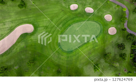 Aerial view golf course with lush greens, putting green, fairway and sand bunker, Golf course green grass and trees fairway and putting green, Beautiful golf course. Aerial view golf course with lush greens, putting green, fairway and sand bunker, Golf course green grass and trees fairway and putting green, Beautiful golf course. 127624769