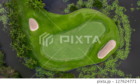 Aerial view golf course with lush greens, putting green, fairway and sand bunker, Golf course green grass and trees fairway and putting green, Beautiful golf course. 127624771