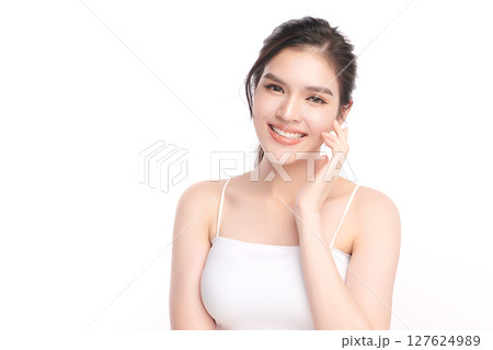 A beautiful young Asian woman with clean, fresh skin against a white background. Skincare, facial treatment, cosmetology, beauty, and spa. An elegant portrait of an Asian woman. A beautiful young Asian woman with clean, fresh skin against a white background. Skincare, facial treatment, cosmetology, beauty, and spa. An elegant portrait of an Asian woman. 127624989