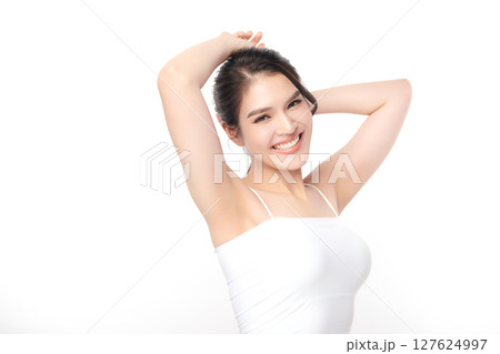 Beautiful Young Asian woman Raises her hands to Showcase clean and hygienic underarms Against a white background, Smooth armpit cleanliness and protection concept Beautiful Young Asian woman Raises her hands to Showcase clean and hygienic underarms Against a white background, Smooth armpit cleanliness and protection concept 127624997