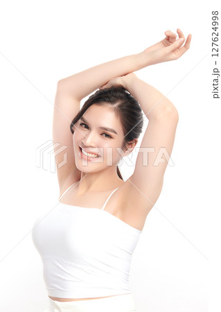 Beautiful Young Asian woman Raises her hands to Showcase clean and hygienic underarms Against a white background, Smooth armpit cleanliness and protection concept Beautiful Young Asian woman Raises her hands to Showcase clean and hygienic underarms Against a white background, Smooth armpit cleanliness and protection concept 127624998