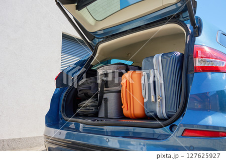 Car trunk full of suitcases and travel bags ready for relocation or road trip Car trunk full of suitcases and travel bags ready for relocation or road trip 127625927