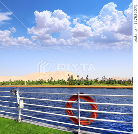 View from cruise ship on the Nile river, Egypt, Africa. Luxury Nile Cruise. Famous tourist attraction. Summer relaxing on cruise ships. Topic of travel, trip abroad on vacation, cruises and tours View from cruise ship on the Nile river, Egypt, Africa. Luxury Nile Cruise. Famous tourist attraction. Summer relaxing on cruise ships. Topic of travel, trip abroad on vacation, cruises and tours 127626079