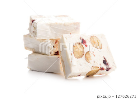 White nougat bars with almonds and dried fruit isolated on white background. White nougat bars with almonds and dried fruit isolated on white background. 127626273