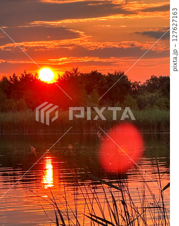 Serene Sunset Reflection Over a Tranquil Lake 127627163