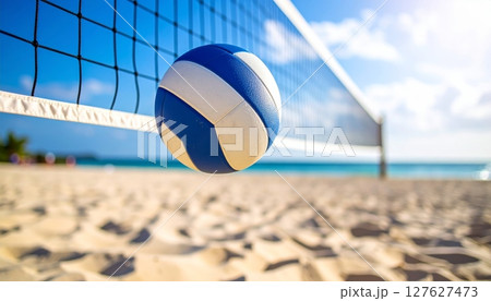 Colorful volleyball on a sandy beach with a net, under a summer sky by the blue ocean, ready for fun 127627473
