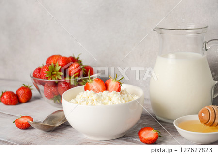 Fresh cottage cheese with fresh strawberries, healthy breakfast concept, selective focus, copy space	 Fresh cottage cheese with fresh strawberries, healthy breakfast concept, selective focus, copy space	 127627823
