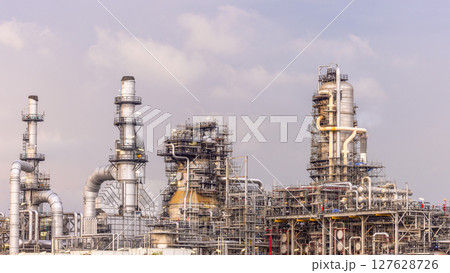 Oil refinery petrochemical plant at dusk illuminated storage tank industrial infrastructure, Oil refinery petrochemical product storage tank at oil refinery factory industry, Global energy refinery. 127628726