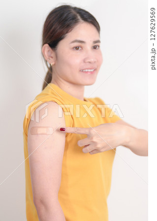 Adult Woman with bandage after received vaccine. Vaccination and Immunization for Influenza, HPV, Zoster, IPD, DTP or Diphtheria, Tetanus and Pertussis, MMR, Hepatitis B, Covid and Varicella vaccine 127629569