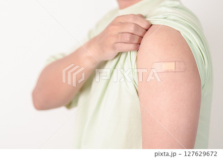 Adult Man with bandage after received vaccine. Vaccination and Immunization for Influenza, HPV, Zoster, IPD, DTP or Diphtheria, Tetanus and Pertussis, MMR, Hepatitis B, Covid and Varicella vaccine Adult Man with bandage after received vaccine. Vaccination and Immunization for Influenza, HPV, Zoster, IPD, DTP or Diphtheria, Tetanus and Pertussis, MMR, Hepatitis B, Covid and Varicella vaccine 127629672