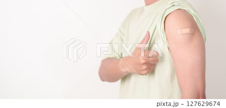 Adult Man with bandage after received vaccine. Vaccination and Immunization for Influenza, HPV, Zoster, IPD, DTP or Diphtheria, Tetanus and Pertussis, MMR, Hepatitis B, Covid and Varicella vaccine 127629674