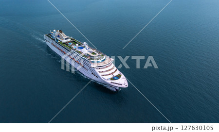 Aerial view luxury ocean cruise ship on clam blue sea, Elegant modern travel lifestyle, Luxury cruise ship liner modern maritime business ocean tourism, Global business cruise ship liner industry. Aerial view luxury ocean cruise ship on clam blue sea, Elegant modern travel lifestyle, Luxury cruise ship liner modern maritime business ocean tourism, Global business cruise ship liner industry. 127630105