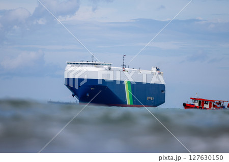 RoRo Ship business logistic and transportation sea freight, Cargo and RoRo ship Roll On Roll Off ship at sea, Car carrier ship RO-RO Roll on Roll off, Vehicle carrier ship in storm. 127630150