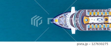 Aerial view luxury ocean cruise ship on clam blue sea, Elegant modern travel lifestyle, Luxury cruise ship liner modern maritime business ocean tourism, Global business cruise ship liner industry. Aerial view luxury ocean cruise ship on clam blue sea, Elegant modern travel lifestyle, Luxury cruise ship liner modern maritime business ocean tourism, Global business cruise ship liner industry. 127630275