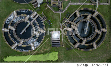 Aerial view westewater treatment tank with wastewater, Circle circular water clarifier cleaning water, Circle water treatment plant circular clarifier, Water treatment plant. 127630331