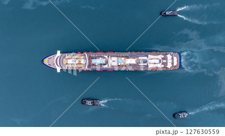 Aerial view luxury ocean cruise ship on clam blue sea, Elegant modern travel lifestyle, Luxury cruise ship liner modern maritime business ocean tourism, Global business cruise ship liner industry. Aerial view luxury ocean cruise ship on clam blue sea, Elegant modern travel lifestyle, Luxury cruise ship liner modern maritime business ocean tourism, Global business cruise ship liner industry. 127630559