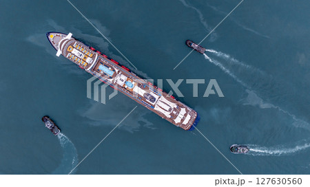 Aerial view luxury ocean cruise ship on clam blue sea, Elegant modern travel lifestyle, Luxury cruise ship liner modern maritime business ocean tourism, Global business cruise ship liner industry. Aerial view luxury ocean cruise ship on clam blue sea, Elegant modern travel lifestyle, Luxury cruise ship liner modern maritime business ocean tourism, Global business cruise ship liner industry. 127630560