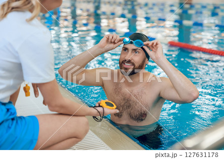 Man having a workout in the swimming pool Man having a workout in the swimming pool 127631178