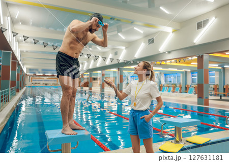 Man having a workout in the swimming pool Man having a workout in the swimming pool 127631181