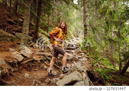 Young woman with backpack traveling outdoors. Hiking, active lifestyle. 127631447