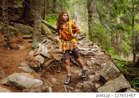 Young woman with backpack traveling outdoors. Hiking, active lifestyle. 127631467