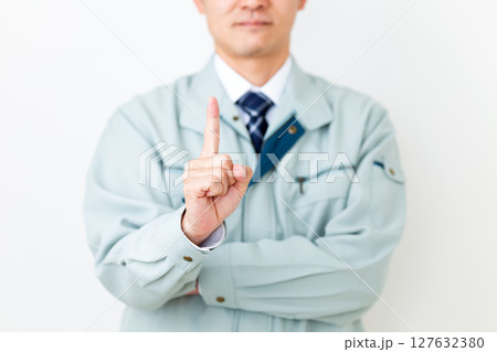 グリーンの作業服を着て人差し指を立てるミドル男性ビジネスマン 127632380