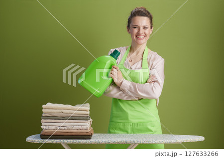 Confident woman with detergent near ironing board Confident woman with detergent near ironing board 127633266