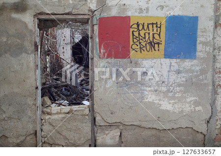 View thru the door in a room of a ruined house. 127633657